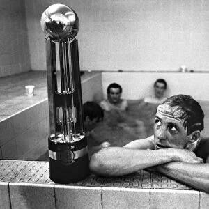 Phil Neal admires the Canon League trophy in the bath as Liverpool clinch another League