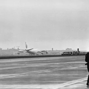 Photographer on the apron following the arrival of the first Boeing 747