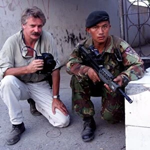 Photographer Mike Moore with Gurkha soldier on patrol in Dilli
