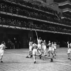 Physical training competition by London Fire Force. Opposing side man throws a ring Physical training competition by London Fire Force. Opposing side man throws a ring