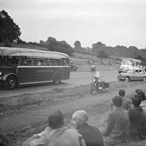 Picnickers sit on the verge watching the traffic on the Sidcup by-pass