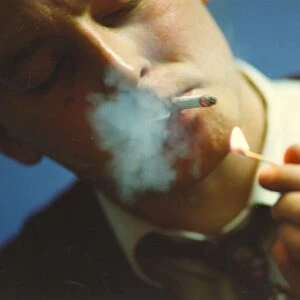 A picture of a man (Posed model) smoking
