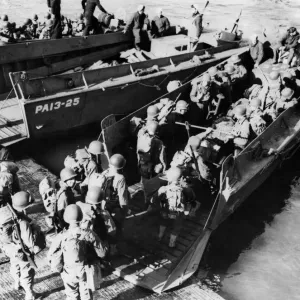This picture shows American troops going aboard a landing craft during the successful This picture shows American troops going aboard a landing craft during the successful