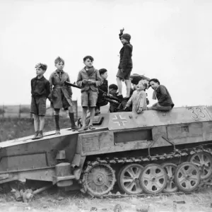 Picture shows children playing on a wrecked Nazi vehicle Picture shows children playing on a wrecked Nazi vehicle