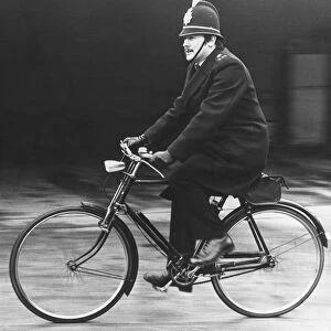 Picture shows an on duty policeman in Cambridgeshire, riding his bicycle