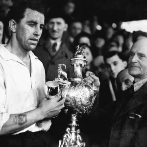 PICTURE SHOWS: Mr E. J. Morgan (vice-president) presenting the Welsh Cup to Roy Paul PICTURE SHOWS: Mr E. J. Morgan (vice-president) presenting the Welsh Cup to Roy Paul
