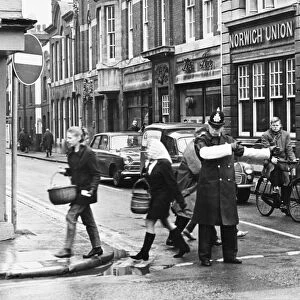 Picture shows a policeman on St Andrews Street, Cambridge, allowing traffic past