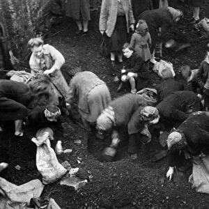 Picture shows women from the Southwark district of London gathering coal from a Bomb site