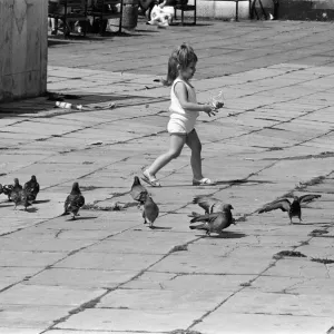 Pier Head, Liverpool, Merseyside, 17th August 1988. Young child plays with pigeons Pier Head, Liverpool, Merseyside, 17th August 1988. Young child plays with pigeons