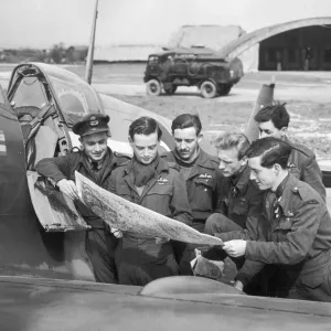 Pilots of No 132 Squadron with their CO, Squadron Leader Alan Page (holding map)