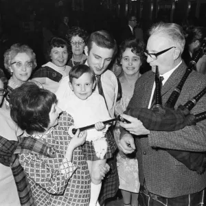 Piper plays for a small group of people attending a New Years Dance at the Regis Hall