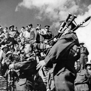 Pipers playing during an off duty spell to men of the Canadian Forestry Corps