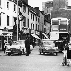 Police directing traffic coming down the Burges in Coventry city centre. 23rd July 1963