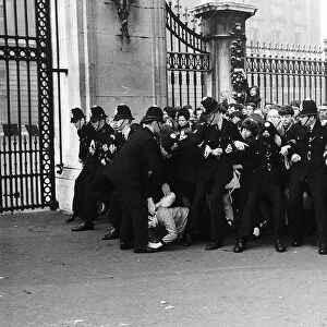 Police hold back the crowds outside Buckingham Palace, as they wait for a glimpse of