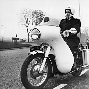 A police motorcycle patrol officer at work in Cambridgeshire. 25th November 1966