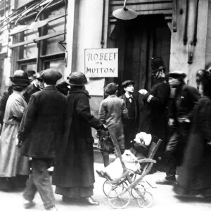 A policeman check the identity papers of a young man, outside a butchers in London A policeman check the identity papers of a young man, outside a butchers in London