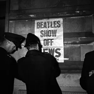 Policemen in Portsmouth, putting up posters which read "BEATLES SHOW OFF"