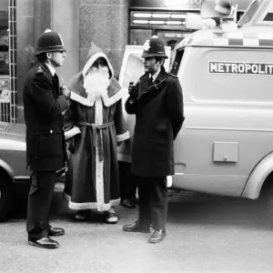 Policemen speak to Santa Claus outside the Harrods Store in London Policemen speak to Santa Claus outside the Harrods Store in London