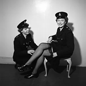 Policewomen Hilda Whitcombe (left) and Betty O Brien trying on the new issue for