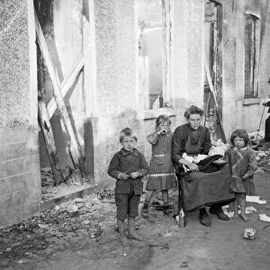 A poor Belgian woman outside her burnt out home in Melle with her four children