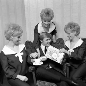 Pop group The Bell sisters from Liverpool serve cereal to Alan David