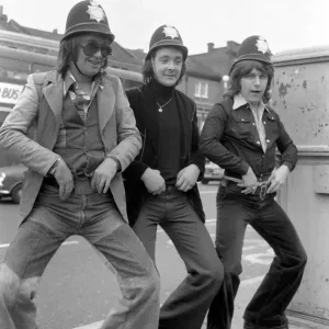 Pop Group Mud'dressed in police helmets May 1975