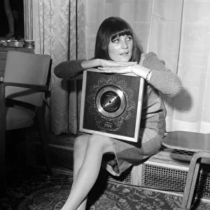 Pop singer Sandie Shaw holding the Silver Disc award for selling 250 000 copies of her
