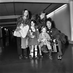Pop star Paul McCartney and family. Carrying a portable radio
