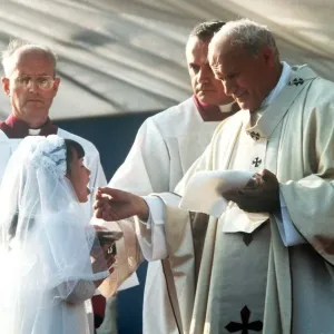 Pope John Paul II giving Holy Communion at Bellahouston Park in Glasgow, Scotland Pope John Paul II giving Holy Communion at Bellahouston Park in Glasgow, Scotland