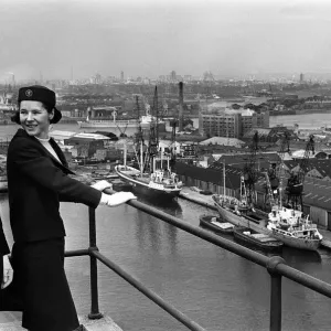 Port of London Dock Guides, June 1965. Two of the guides talk as they look over Port of London Dock Guides, June 1965. Two of the guides talk as they look over