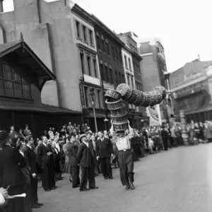 Porters from Covent Garden Flower and Vegetable market race with baskets stacked on their Porters from Covent Garden Flower and Vegetable market race with baskets stacked on their