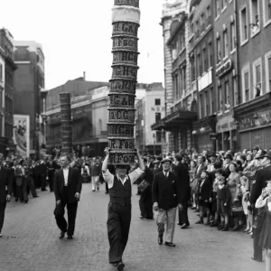 Porters from Covent Garden Flower and Vegetable market race with baskets stacked on their Porters from Covent Garden Flower and Vegetable market race with baskets stacked on their