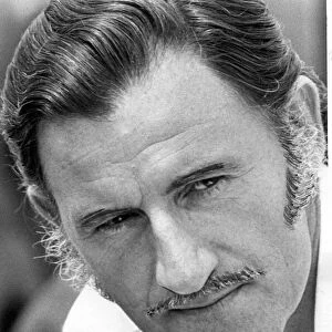 A portrait of Graham Hill pictured at Silverstone
