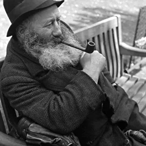Portrait of an old man seen here smoking his pipe Circa 1938