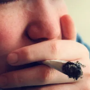 A posed model picture of an underage smoker