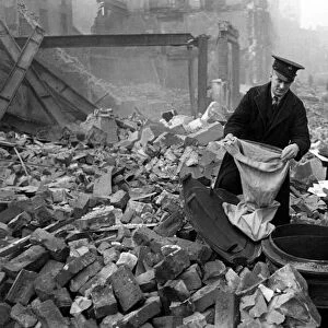 Postmen shift through the wreckage of their central London sorting office looking for