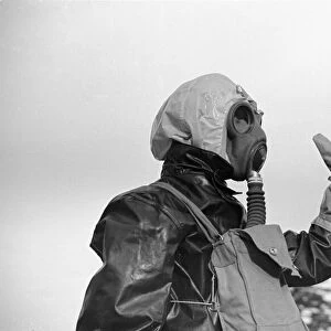 Preparations for war. ARP warden gets use to his gas mask