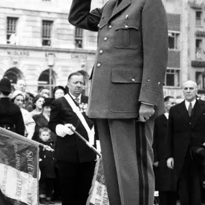 President Charles De Gaulle - salutes in front of the Marshall Foch statue in President Charles De Gaulle - salutes in front of the Marshall Foch statue in