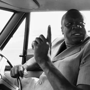 President Idi Amin at the wheel of his Range Rover at Entebbe Airport near Kampala President Idi Amin at the wheel of his Range Rover at Entebbe Airport near Kampala