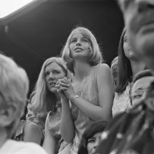 A pretty young Tennis Fan watches the Taylor v Drysdale match at Wimbledon Tennis
