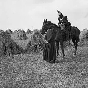 A priest talks to a French Cuirassiers in a corn field on the Belgium - France border
