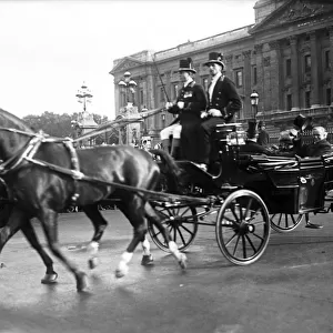 Prime Minister David Lloyd George, driving in an open horse drawn carriage outside