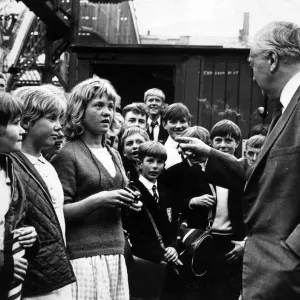 Prime Minister Harold Wilson pauses to chat with a group of children who met his train Prime Minister Harold Wilson pauses to chat with a group of children who met his train