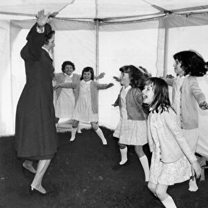 Prime Minister Margaret Thatcher seen here leading a group of children in a session of