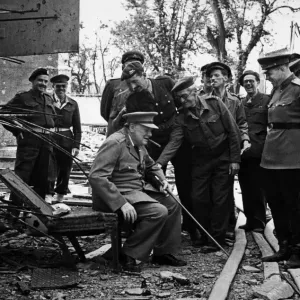 Prime Minister Winston Churchill rests on one of the damaged chairs from the bunker in Prime Minister Winston Churchill rests on one of the damaged chairs from the bunker in
