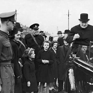 Prime Minister Winston Churchill sitting on the back of an open car on his surprise visit