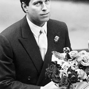 Prince Andrew with bunch of flowers for wife and baby in hospital August 1988