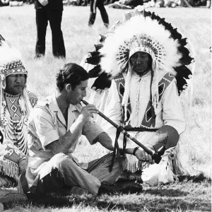 Prince Charles attending a Blackfoot Indian ceremony at Calgary Canada puffs a Prince Charles attending a Blackfoot Indian ceremony at Calgary Canada puffs a