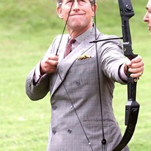 Prince Charles with bow and arrow at archery practice at clay pigeon shoot to raise money