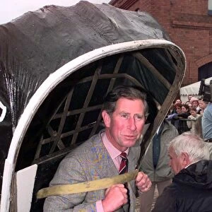 Prince Charles carries a coracle July 1998 during his visit to the Swansea Maritime